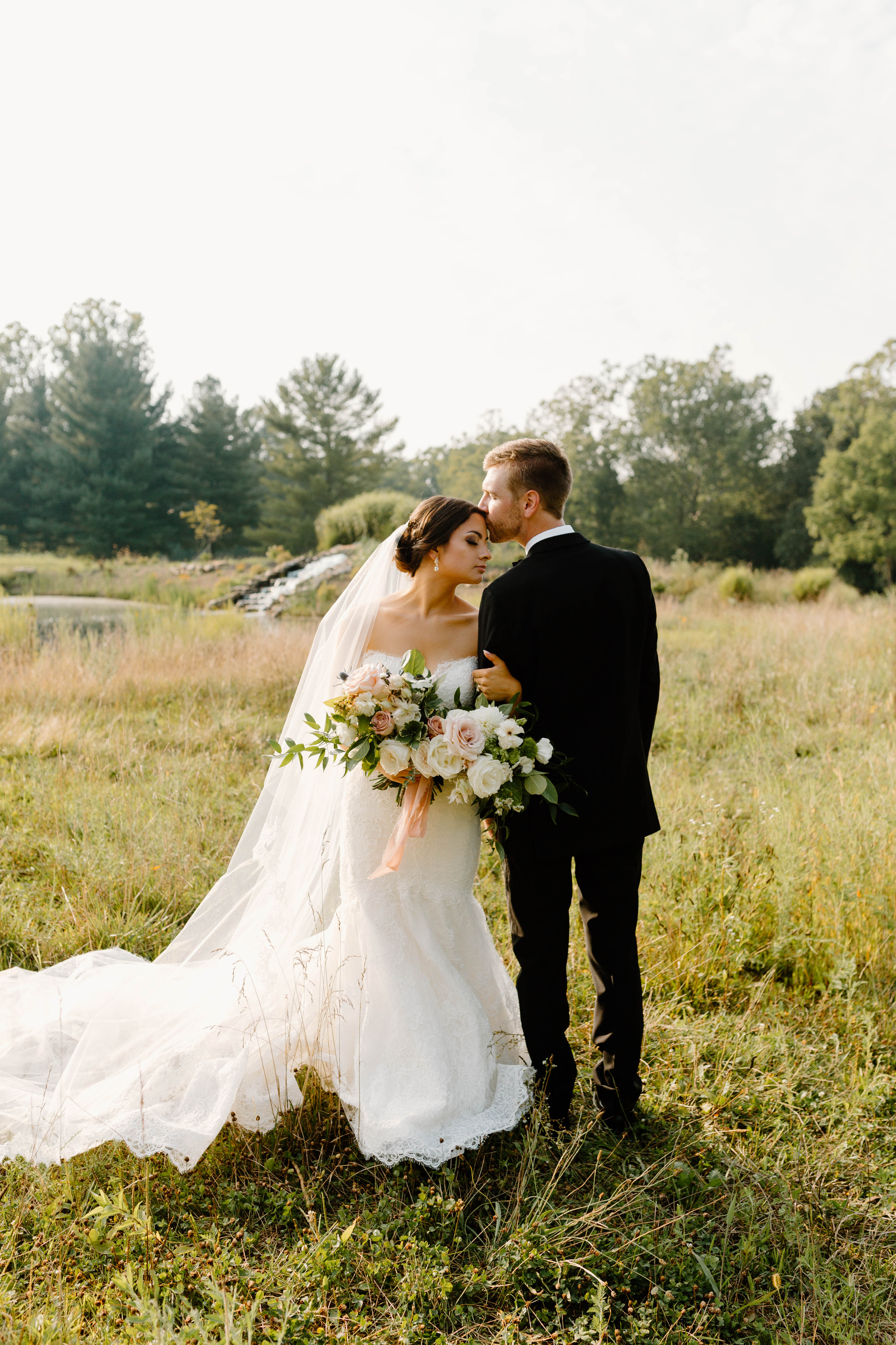 Bride and groom in a field | Cincinnati Wedding Planner